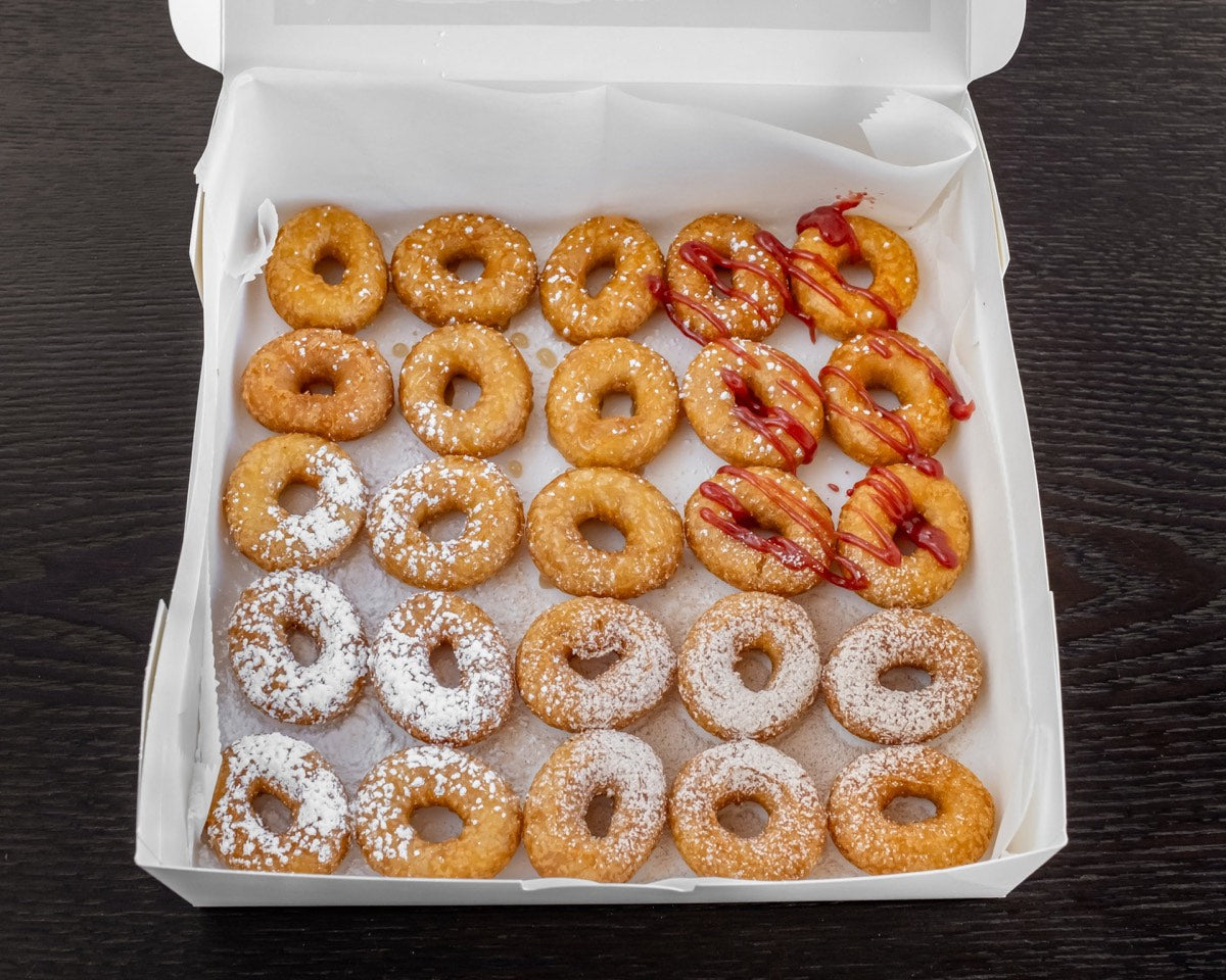 Two dozen mini donuts boxed and sealed for shipping